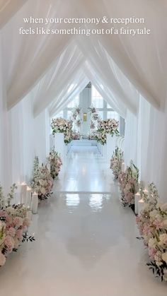 the aisle is decorated with flowers and candles