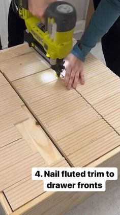 a person using a power tool to cut wood planks with a jig saw