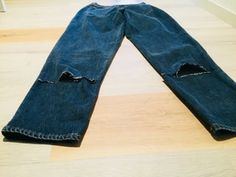 a pair of blue jeans with holes in them