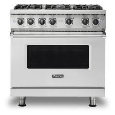 a white stove with four burners and two oven doors on each side, in front of a white background