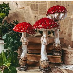 two red mushrooms sitting on top of books