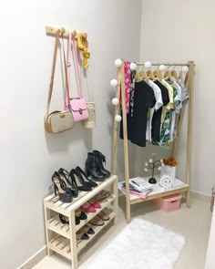 a closet with shoes and purses hanging on the wall next to a rack filled with clothes