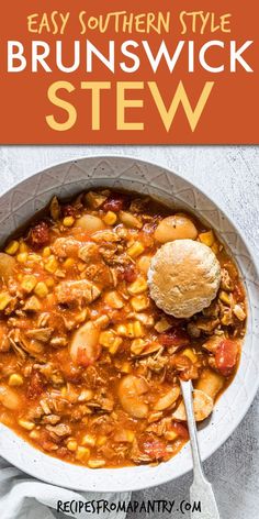 a white bowl filled with stew next to a spoon