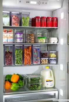 a refrigerator filled with lots of different types of vegetables and fruit in containers on the shelves