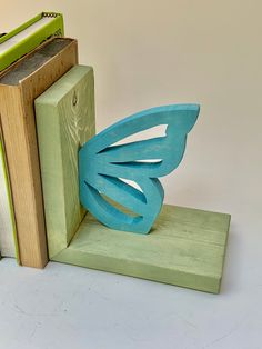 a bookend made out of wood with a butterfly on it