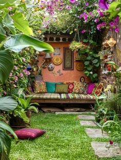 a garden with lots of plants and flowers on the walls, grass in the foreground