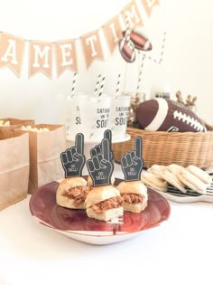 a plate with sandwiches on it and two thumbs up signs in the shape of fingers