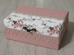 a pink and white box sitting on top of a wooden floor