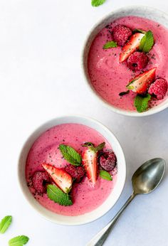 two bowls of smoothie with strawberries and mint