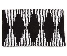 a black and white rug with vertical lines on the side, in front of a white background