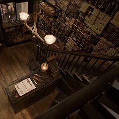 an overhead view of a staircase in a building with books on the walls and wooden floors