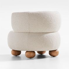 two white stools stacked on top of each other with wooden legs and wheels in front of them