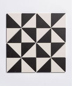 a black and white tile with triangles on it's sides, all in different sizes