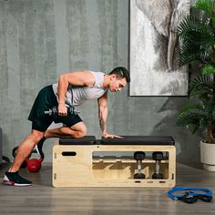 a man doing exercises on a bench in the middle of a room with other equipment