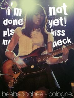 a woman with long hair playing a guitar