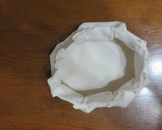 a white cloth diaper sitting on top of a wooden table