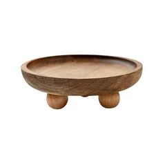 a wooden bowl sitting on top of a table