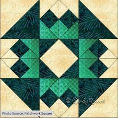 a green and white quilted design with squares on it's sides, in the middle