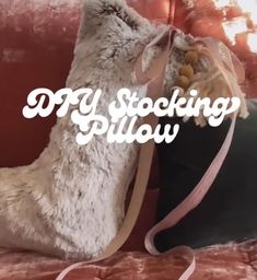 a stuffed animal sitting on top of a couch next to a pillow with the words diy stocking pillow