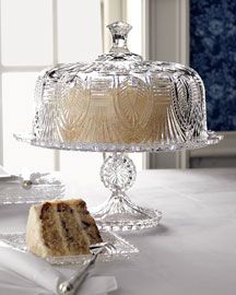 a cake sitting on top of a white table next to a plate with a piece of cake