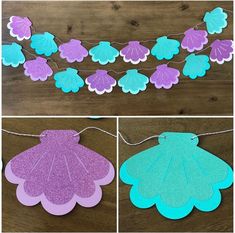 some paper flowers and leaves are hanging on a string with purple, blue and green colors