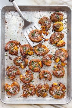 a pan filled with cooked shrimp and topped with parmesan sprinkles