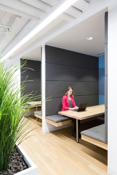 a woman sitting at a table with a laptop