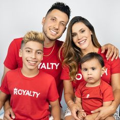 a man and woman with two children wearing red shirts