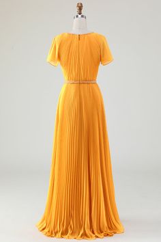 a yellow dress on a mannequin head stand in front of a white background