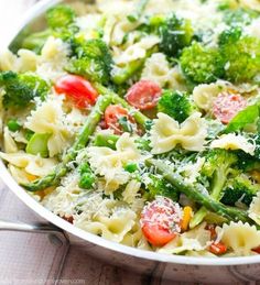 pasta with broccoli, tomatoes and parmesan cheese in a skillet