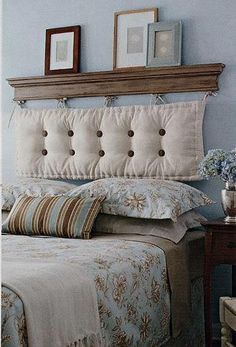 a bedroom with blue walls and white bedding, two framed pictures on the wall