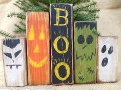 three wooden blocks with halloween decorations on them