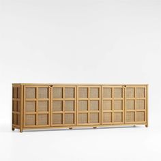 the sideboard is made out of wood and has rattan panels on each side