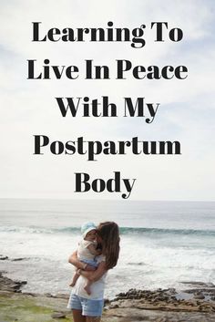 a woman holding a baby in her arms with the words learning to live in peace with my postpartum body