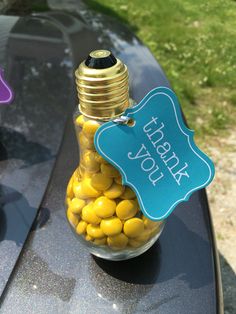 a jar filled with yellow candies sitting on top of a table