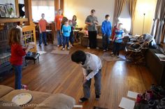 a group of people standing around in a living room