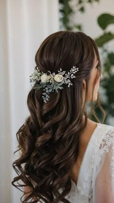 a woman with long brown hair wearing a flower in her hair and flowers in her hair