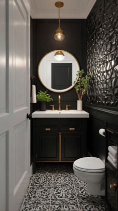 a black and white bathroom with gold accents on the mirror, sink, toilet and vanity