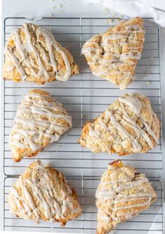 six scones with icing sitting on a cooling rack