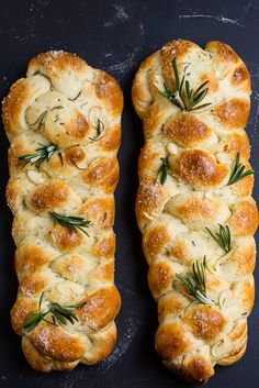 two pieces of bread with rosemary sprigs on top