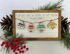 three christmas ornaments are hanging on a string