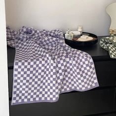 a bed with a checkered blanket on top of it