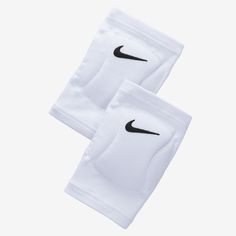 two white knee pads with black nike logo on the front and one has an open pocket for