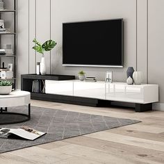 a modern living room with white furniture and a flat screen tv