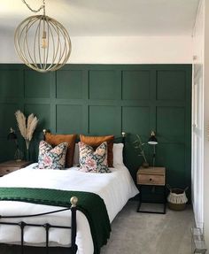 a bedroom with green walls and white bedding