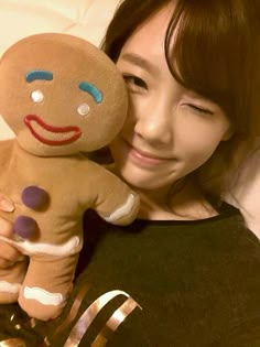 a woman holding a stuffed toy in her arms