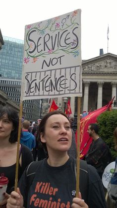 a woman holding a sign that says services not sent to san francisco, killer feminists