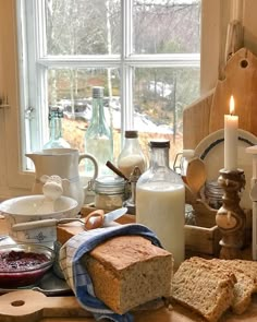 bread, butter and jam are sitting on the kitchen counter