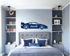 a car decal on the wall above a bed