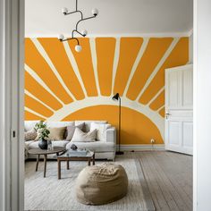 an orange and white living room with sun painted on the wall